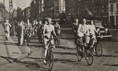Old black and white photo of people riding bicycles in Copenhagen.