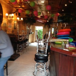 A warmly lit bar and bar stools.
