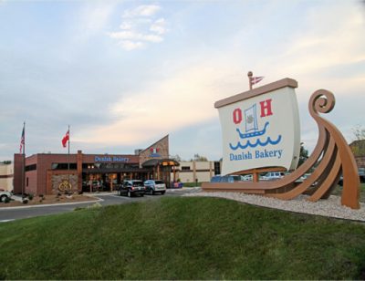 A Danish bakery with a big sign and a wooden viking ship in Racine, Wisconsin.