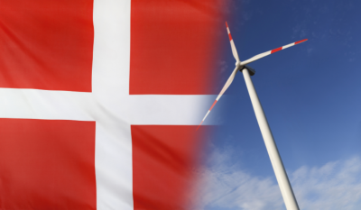 The Danish flag cross next to a wind turbine.