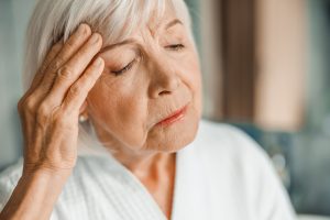 Close up of upset old woman suffering from migraine stock photo